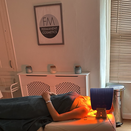 lady lying down having led light therapy